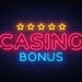 Casino Bonus Neon Text Vector. Bonus neon sign, design template, modern trend design, casino neon signboard, night bright advertising, light banner, light art. Vector illustration.