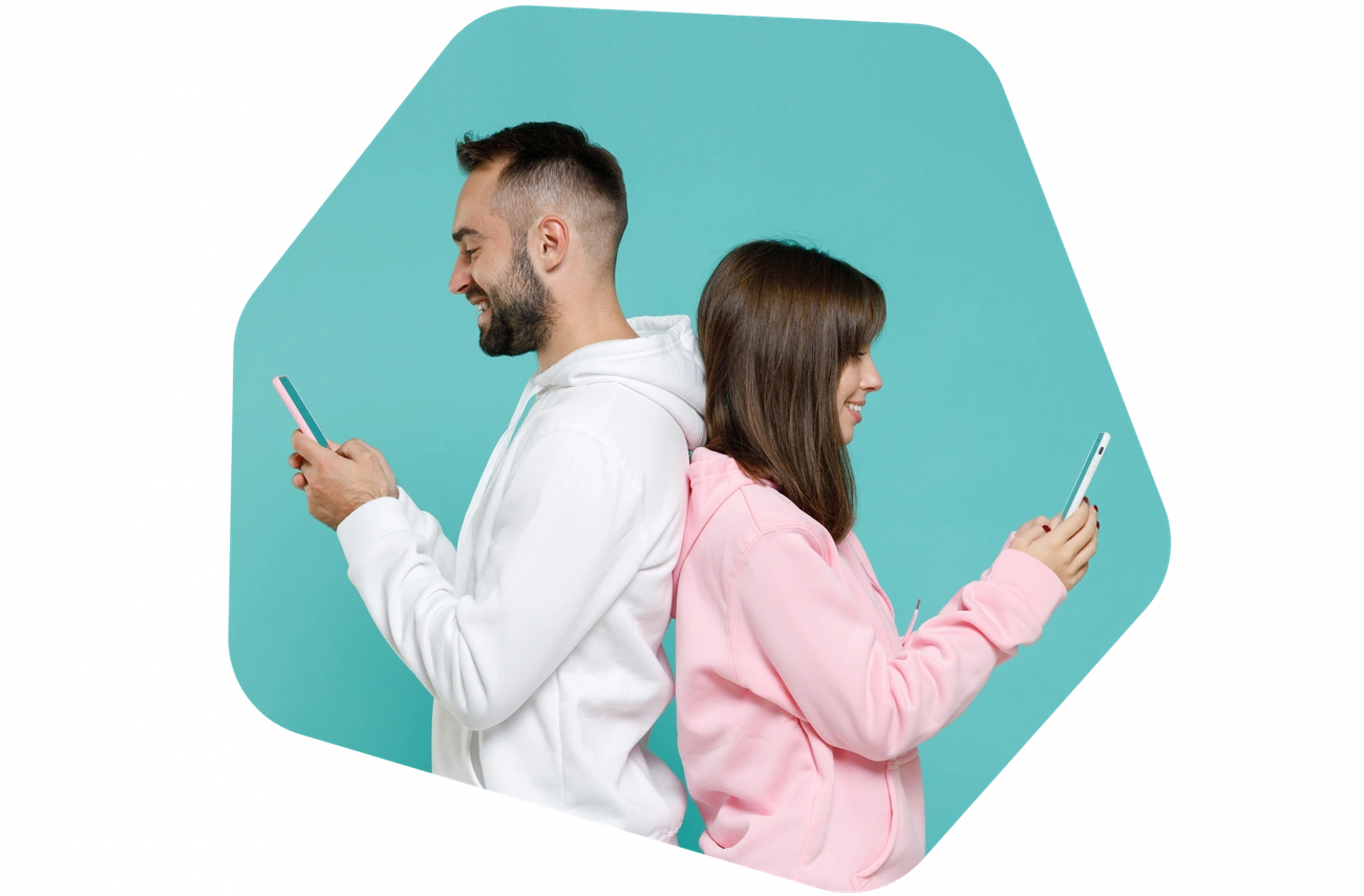 Man and woman standing back to back using smartphones against a blue background, symbolizing online dating privacy.