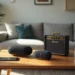 Modern living room with two black Meilleure Enceinte Bluetooth, a Marshall amplifier, smartphone, and glasses on a wooden coffee table
