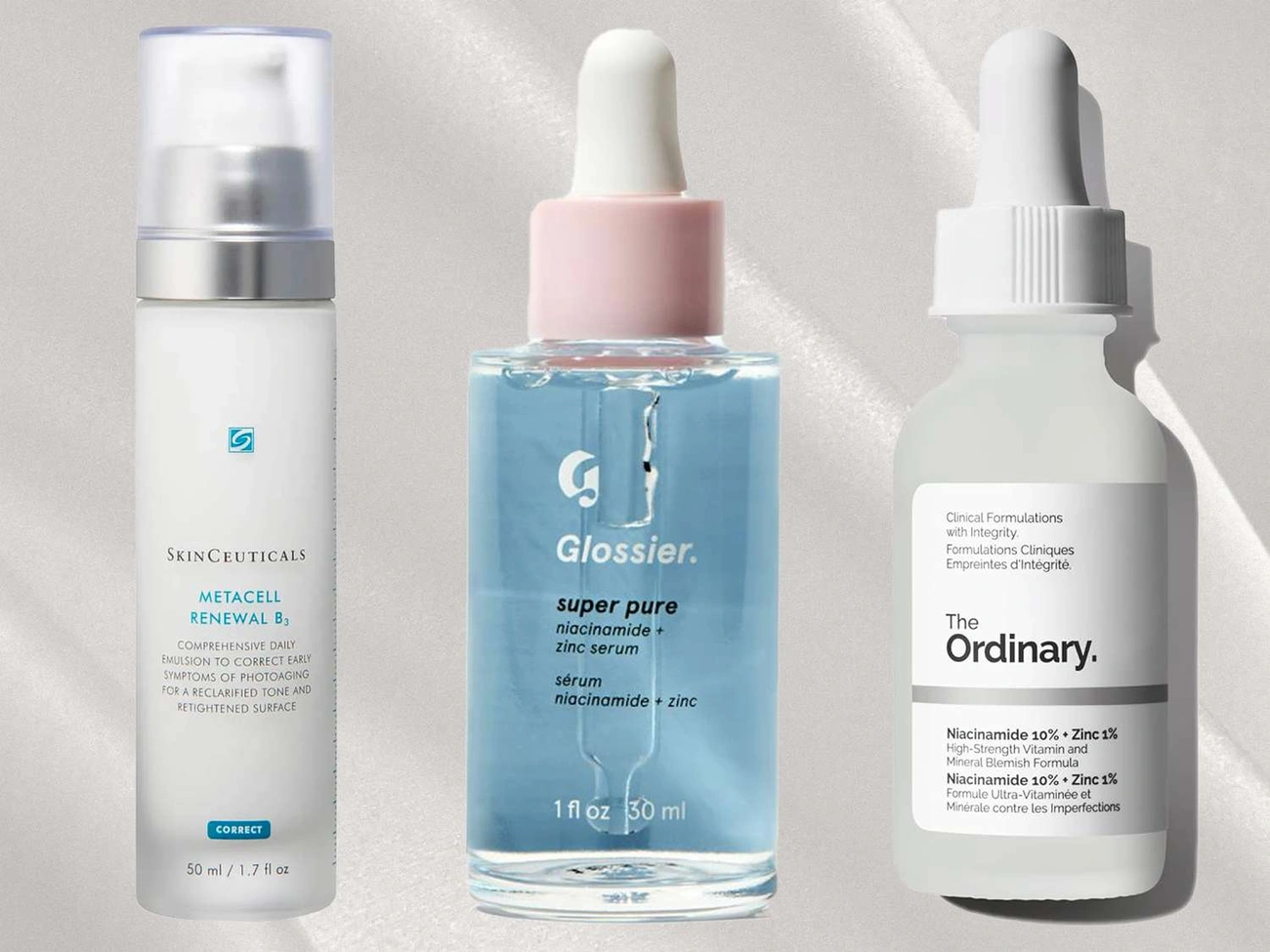 Three niacinamide skincare products from SkinCeuticals, Glossier, and The Ordinary displayed on a light background.