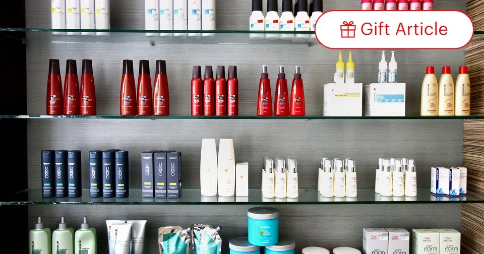 Shelves stocked with various beauty and skincare products displayed in a store setting.